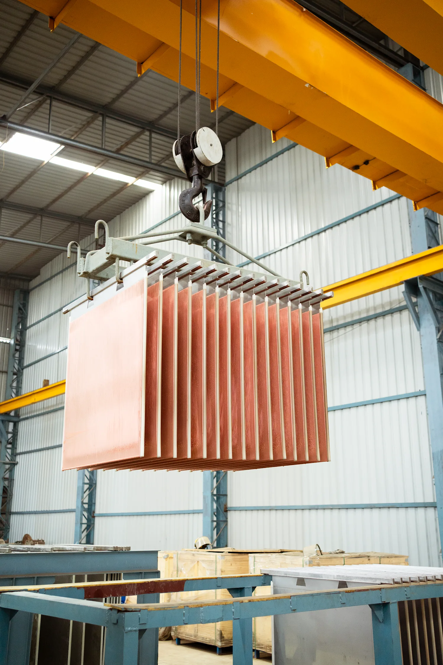 Bundle of refined copper cathodes lifted by crane