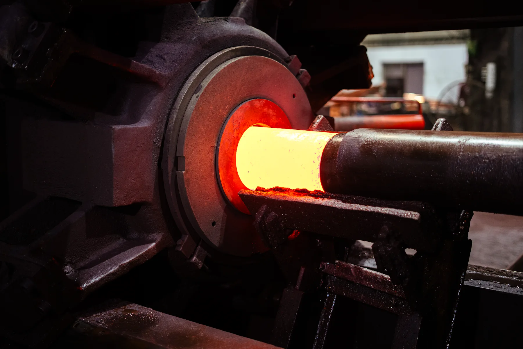 Heated copper billet entering the extrusion press